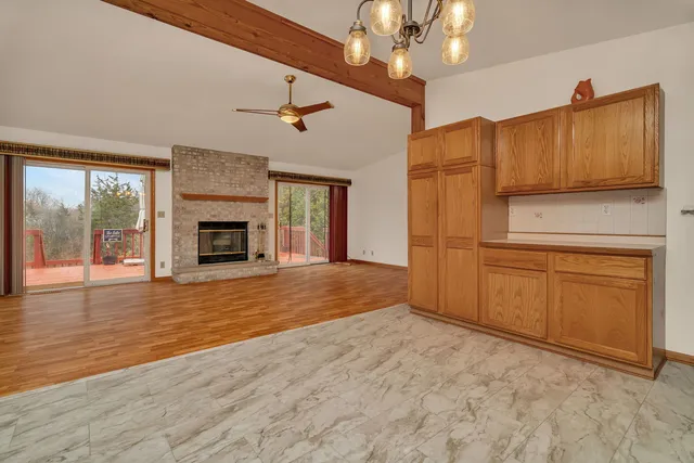 a view of a kitchen with a stove cabinets a fireplace and wooden floor