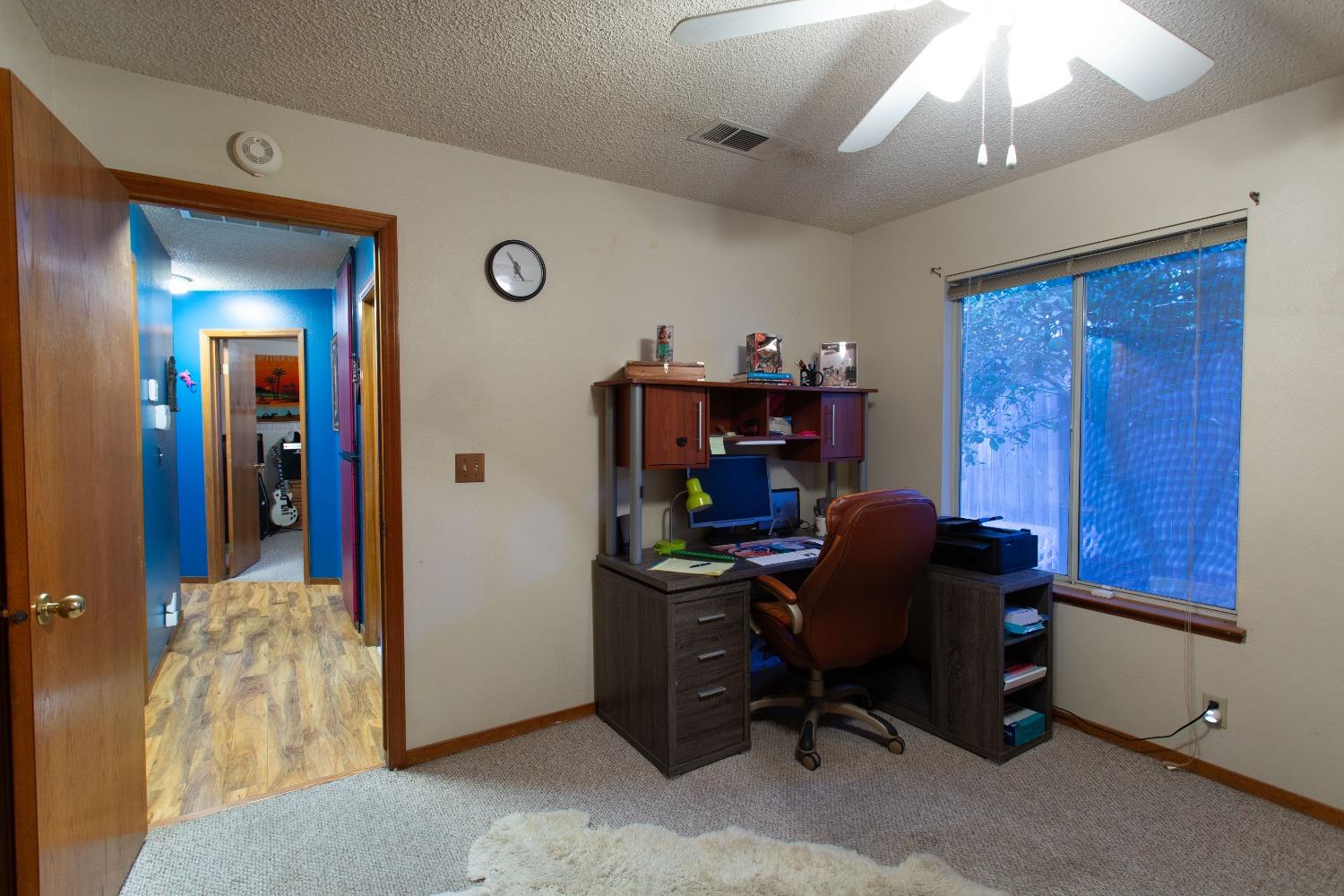 1570 Pine Drive Lemoore, CA 93245 - Photo 13 of 24 a view of a workspace with furniture and a window