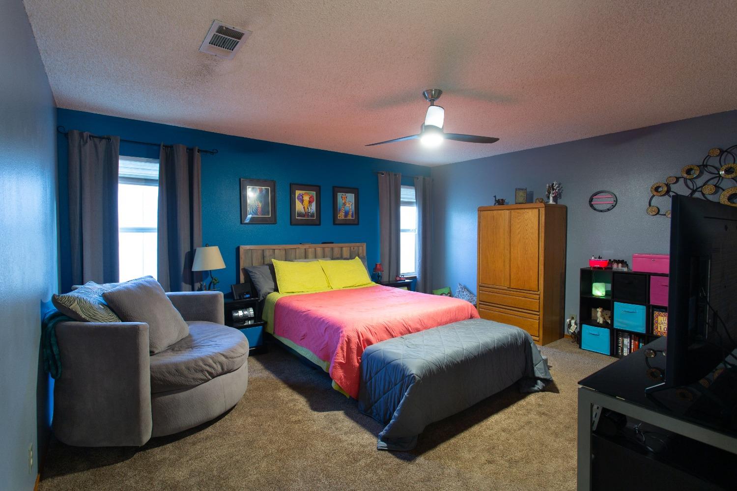 1570 Pine Drive Lemoore, CA 93245 - Photo 14 of 24 a bedroom with a bed and a couch