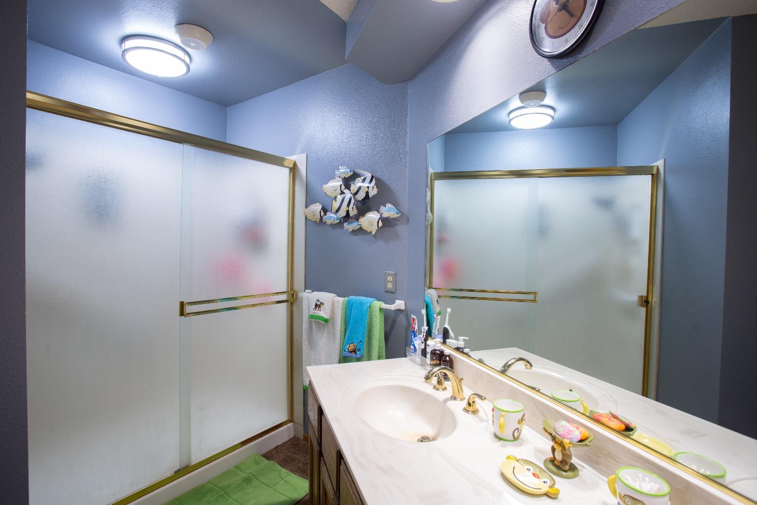 1570 Pine Drive Lemoore, CA 93245 - Photo 16 of 24 a bathroom with a sink and a mirror