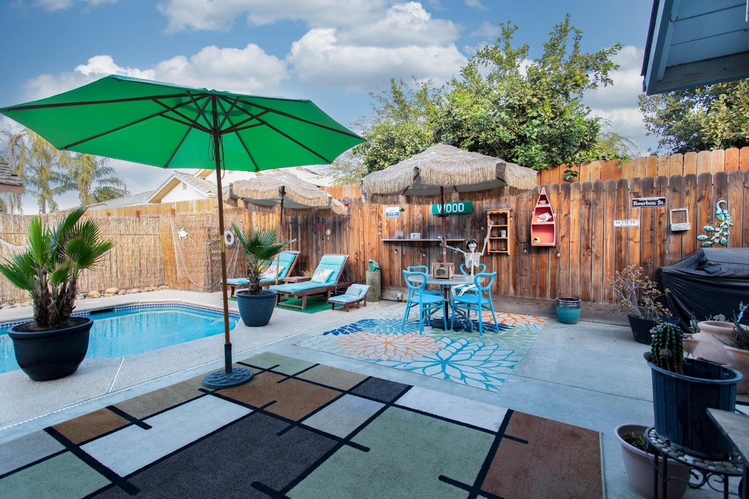 1570 Pine Drive Lemoore, CA 93245 - Photo 18 of 24 a view of a backyard with sitting area and furniture