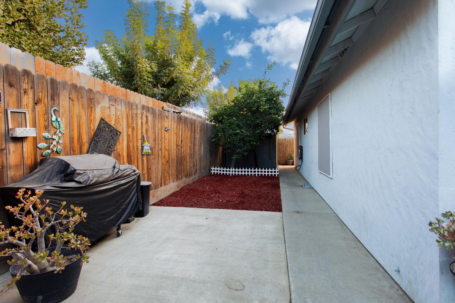 1570 Pine Drive Lemoore, CA 93245 - Photo 19 of 24 a view of a backyard of the house