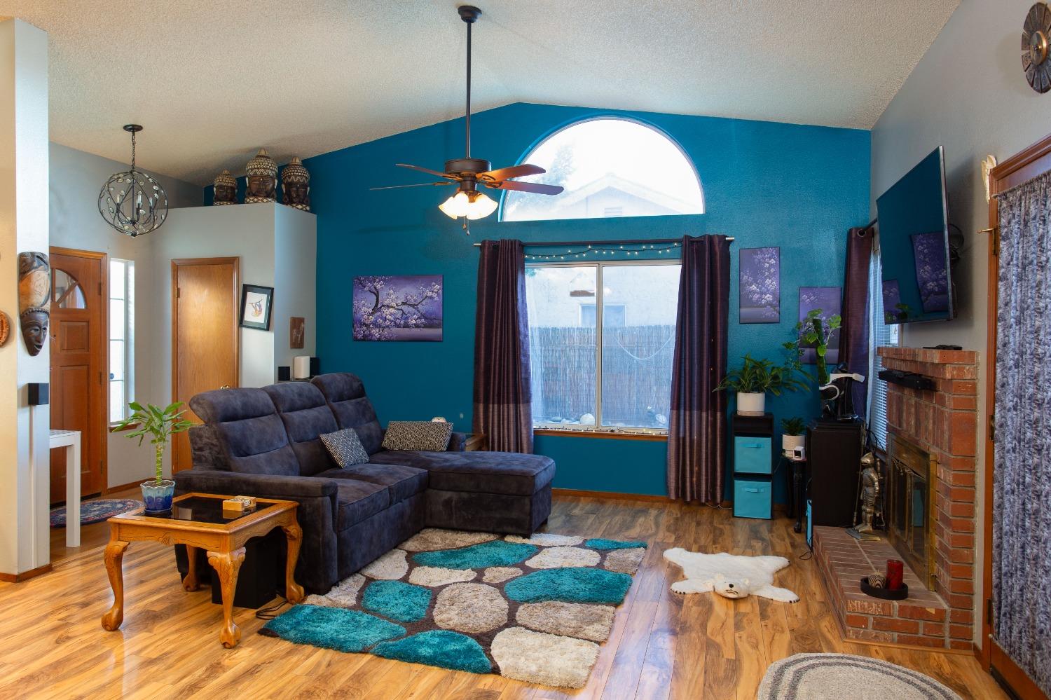 1570 Pine Drive Lemoore, CA 93245 - Photo 4 of 24 a living room with furniture a chandelier and a dining table