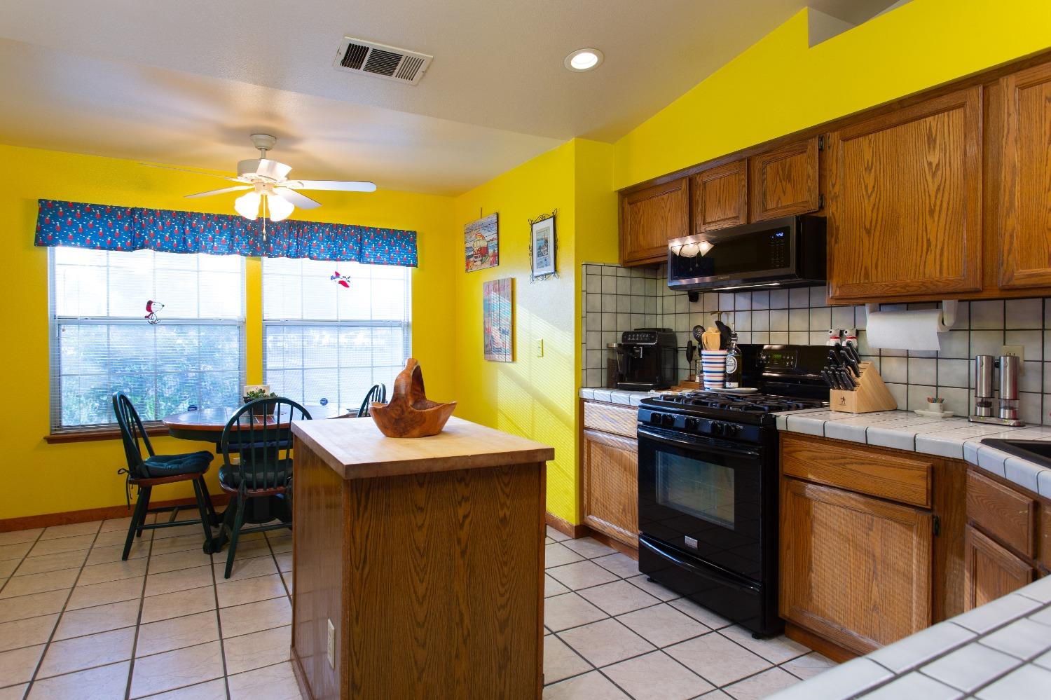 1570 Pine Drive Lemoore, CA 93245 - Photo 7 of 24 a kitchen with stainless steel appliances granite countertop a sink stove and refrigerator
