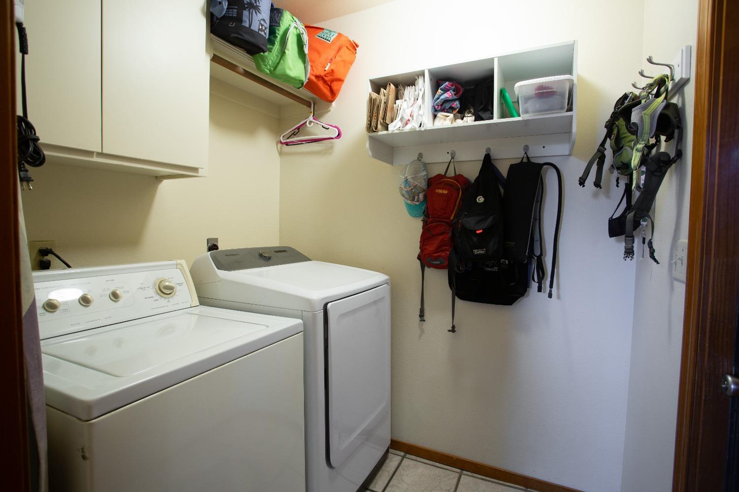 1570 Pine Drive Lemoore, CA 93245 - Photo 10 of 24 a view of walk in closet with clothes and shoes