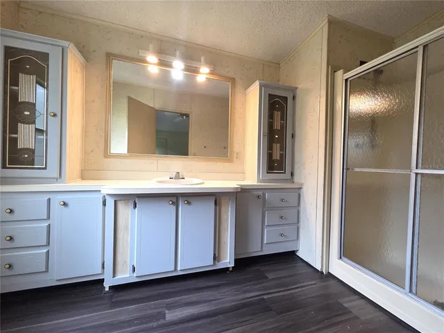 a bathroom with a double vanity sink and mirror