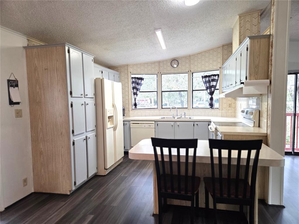 14822 Dilbeck Drive Spring Hill, FL 34610 - Photo 2 of 40 a view of a dining room with furniture window and wooden floor