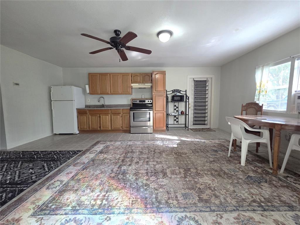 14822 Dilbeck Drive Spring Hill, FL 34610 - Photo 22 of 40 a living room with stainless steel appliances granite countertop furniture and a wooden floor