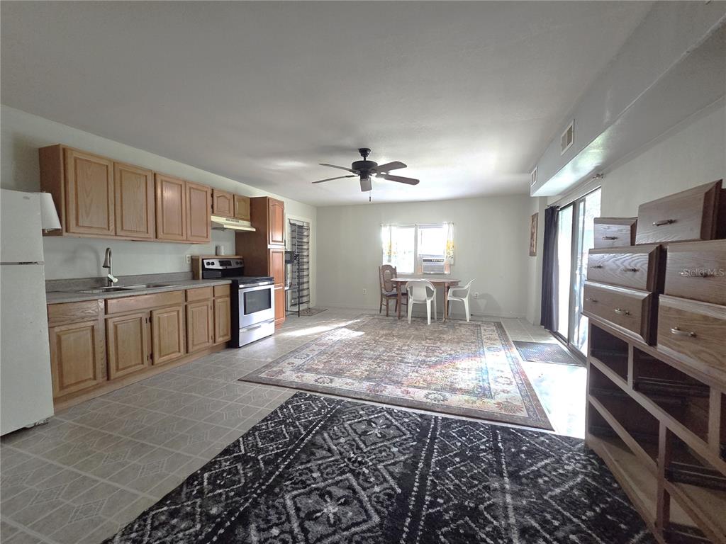 14822 Dilbeck Drive Spring Hill, FL 34610 - Photo 24 of 40 a kitchen with refrigerator cabinets and outdoor
