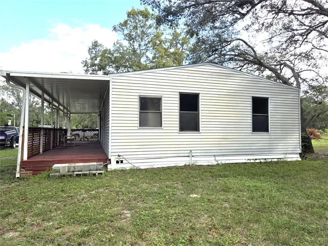 a view of a chair and tables in the patio of a house