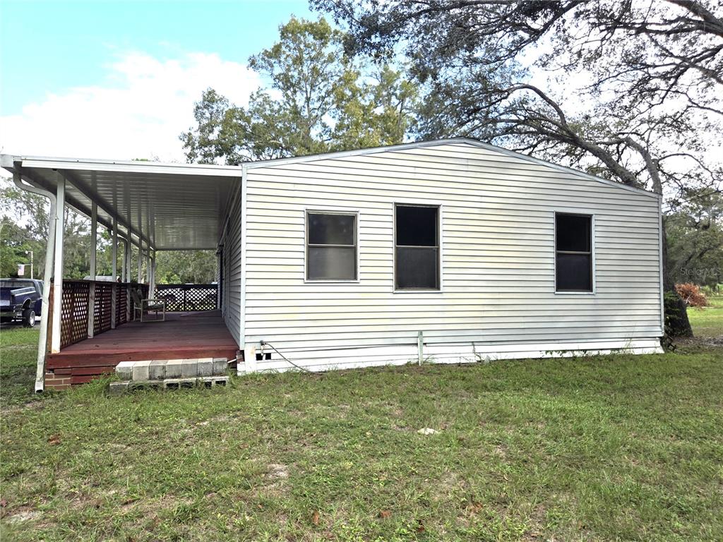 14822 Dilbeck Drive Spring Hill, FL 34610 - Photo 28 of 40 a view of a backyard with plants and large tree