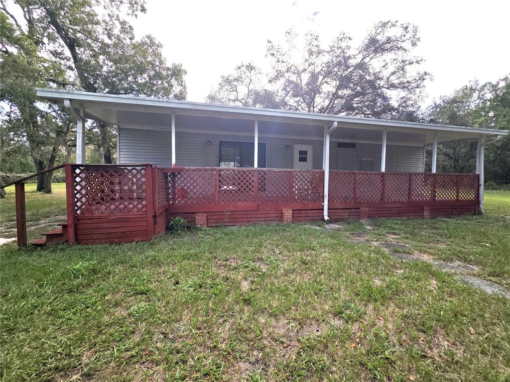 14822 Dilbeck Drive Spring Hill, FL 34610 - Photo 37 of 40 a view of a house with a backyard and chairs