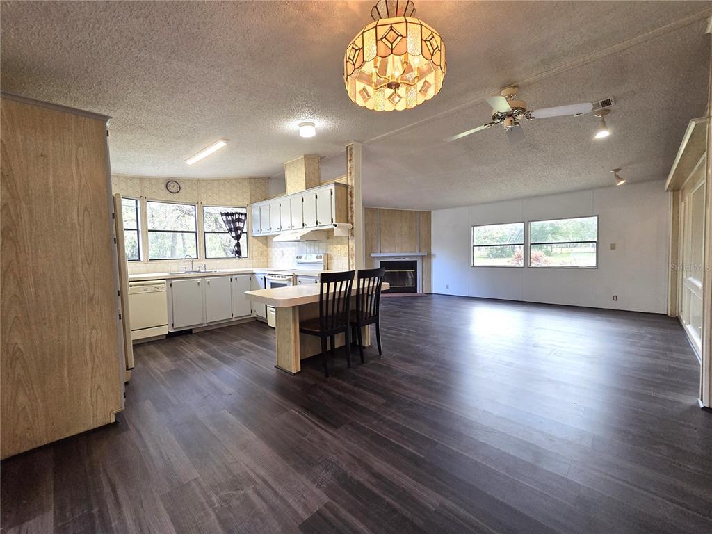 14822 Dilbeck Drive Spring Hill, FL 34610 - Photo 9 of 40 an open kitchen with a table and chairs