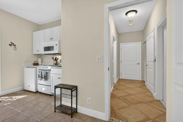 a hallway with cabinets and window