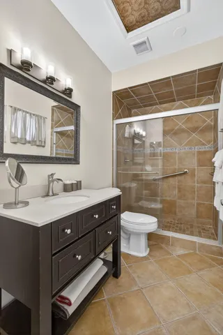 a bathroom with a toilet a sink and mirror