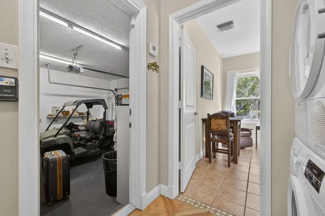 a view of a hallway and a livingroom with furniture