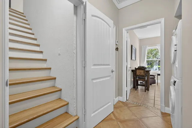 a view of a hallway with wooden floor and a staircase