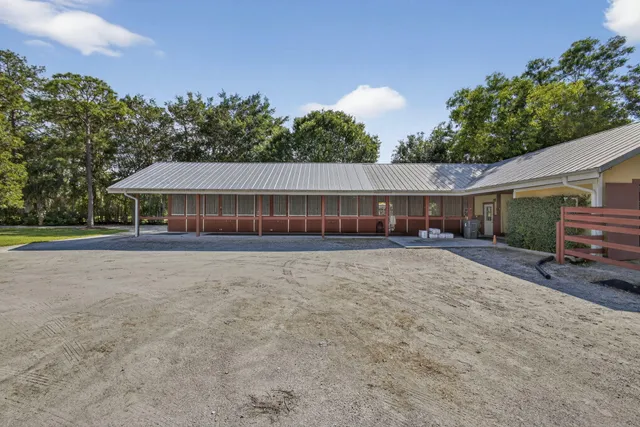 a view of house with outdoor space and sitting area