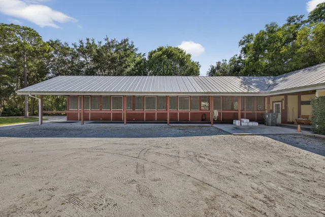 a view of house with outdoor space and parking