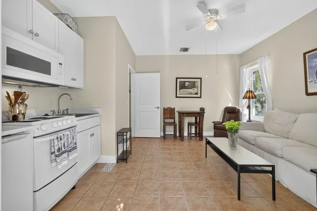 a living room with furniture a dining table and chairs