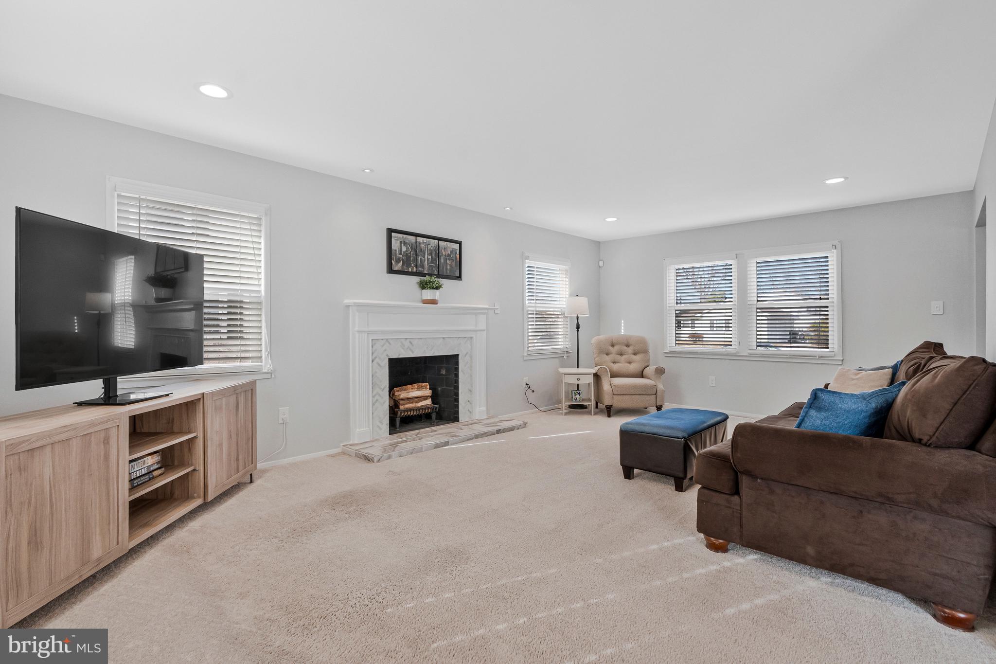 13127 Parson Lane Fairfax, VA 22033 - Photo 12 of 44 a living room with furniture a flat screen tv and a fireplace