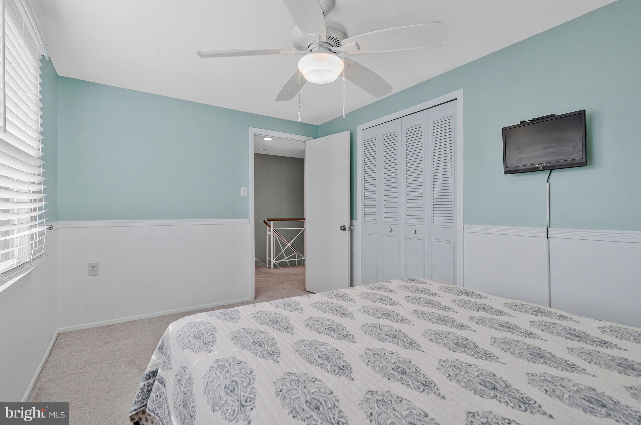 13127 Parson Lane Fairfax, VA 22033 - Photo 34 of 44 a bedroom with a bed and a chandelier