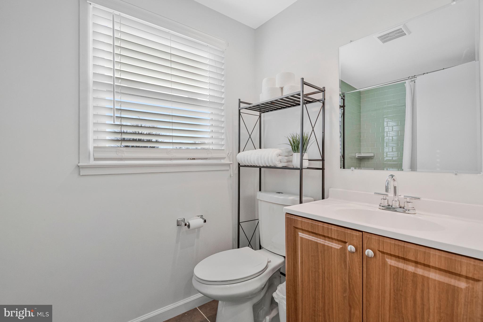 13127 Parson Lane Fairfax, VA 22033 - Photo 35 of 44 a bathroom with a toilet sink and mirror