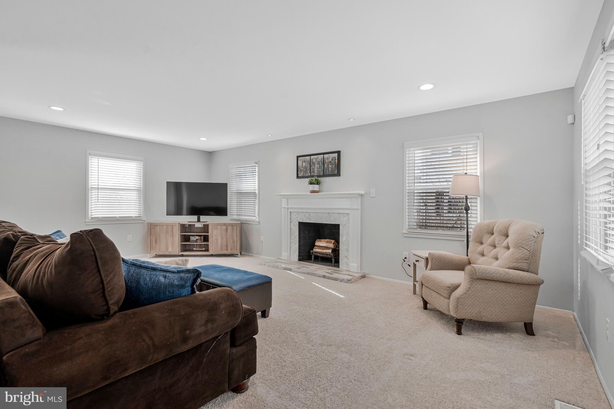 13127 Parson Lane Fairfax, VA 22033 - Photo 10 of 44 a living room with furniture a fireplace and a flat screen tv