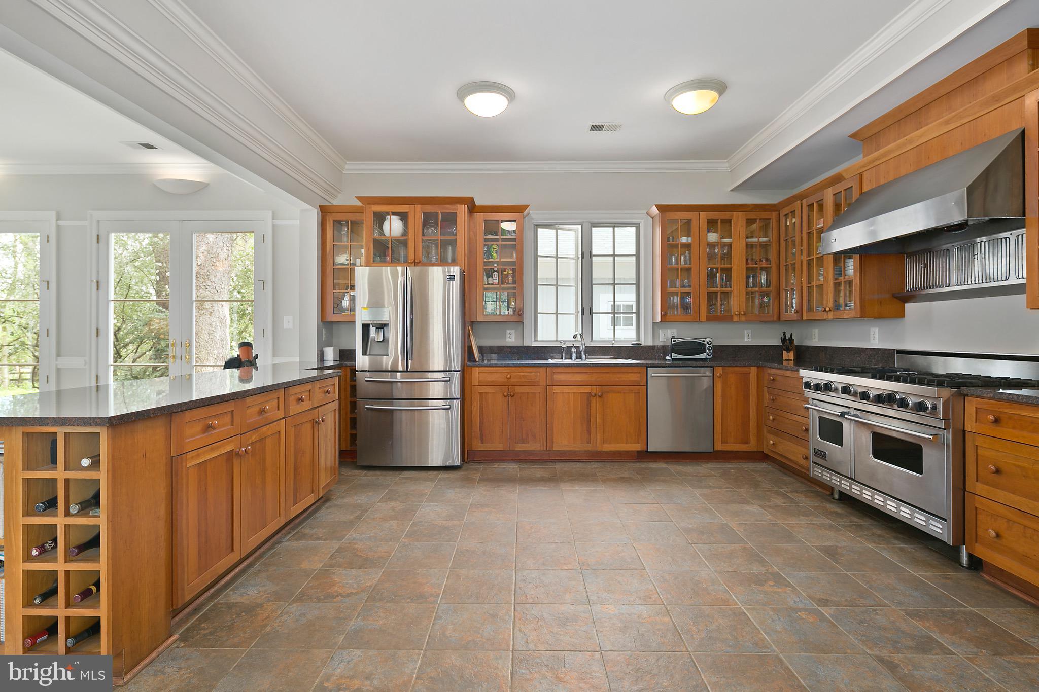 1213 Towlston Road McLean, VA 22102 - Photo 11 of 50 Granite, glass cabinets, stone floor in kitchen