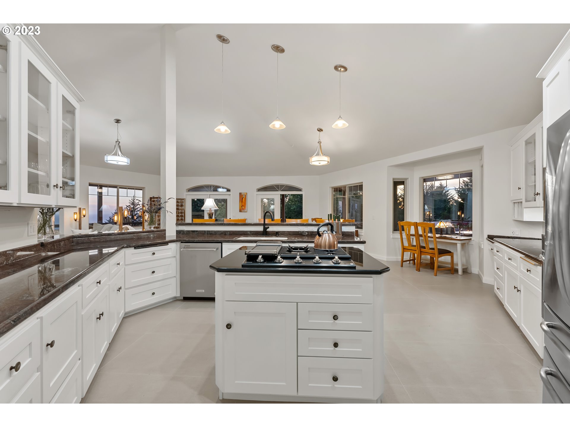 19630 McDonald Road Brookings, OR 97415 - Photo 13 of 36 a kitchen with white cabinets and appliances