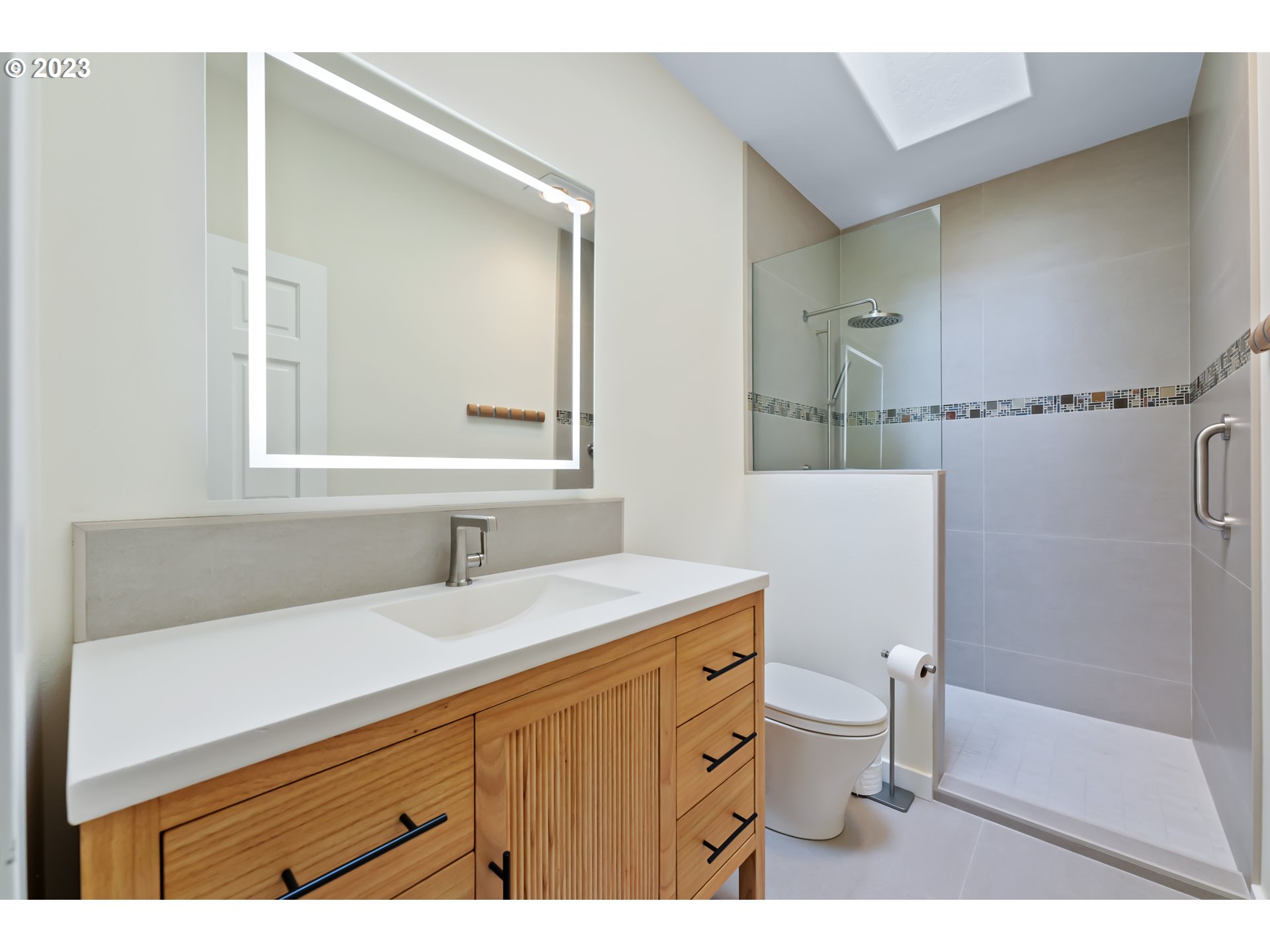19630 McDonald Road Brookings, OR 97415 - Photo 24 of 36 a bathroom with a sink a toilet a mirror and shower