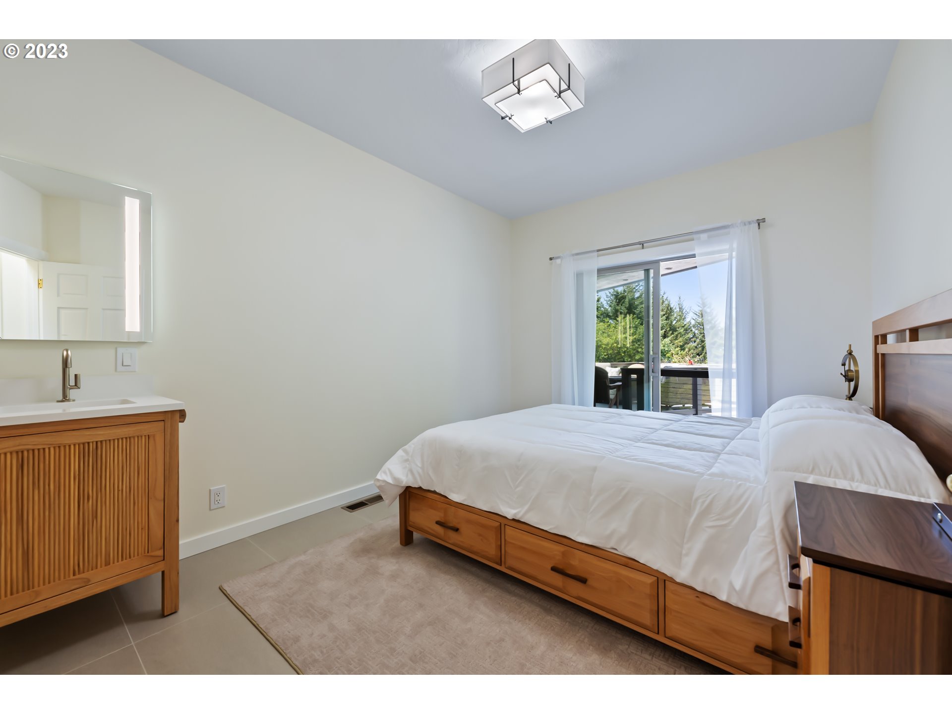 19630 McDonald Road Brookings, OR 97415 - Photo 26 of 36 a bedroom with a bed and a table