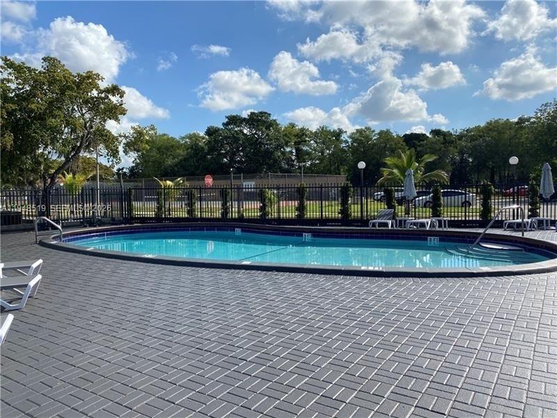 8040 North Colony Circle, Unit 101 Tamarac, FL 33321 - Photo 15 of 15 a view of a swimming pool with a yard