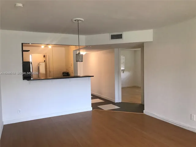 a view of a kitchen with a refrigerator and a ceiling fan