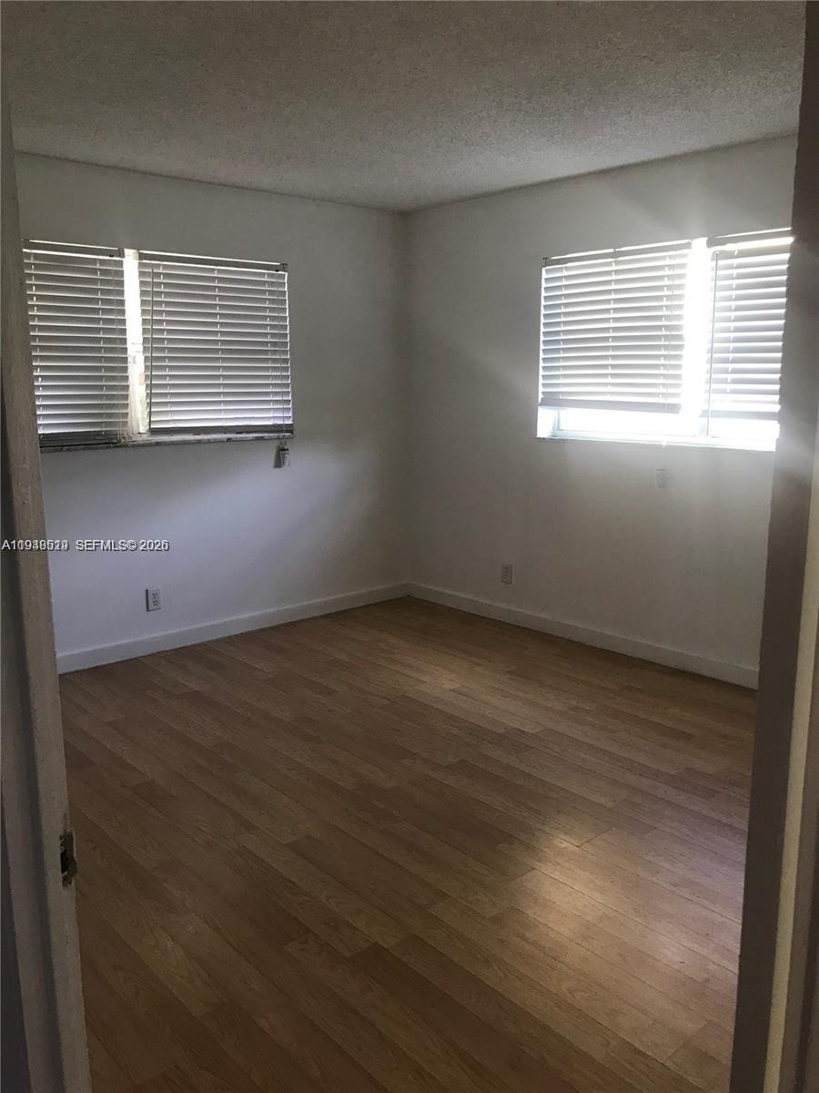 8040 North Colony Circle, Unit 101 Tamarac, FL 33321 - Photo 10 of 15 an empty room with a window