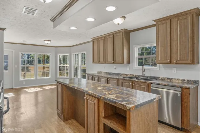 a kitchen with stainless steel appliances granite countertop a sink stove and cabinets