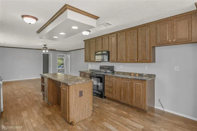 a kitchen with stainless steel appliances granite countertop a stove and a sink