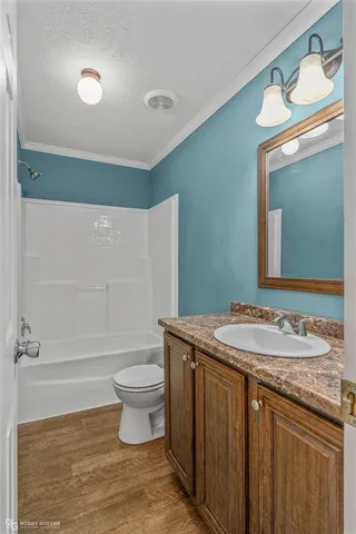 a bathroom with a granite countertop sink a toilet and a mirror