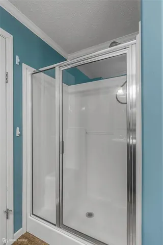 a bathroom with a glass shower door