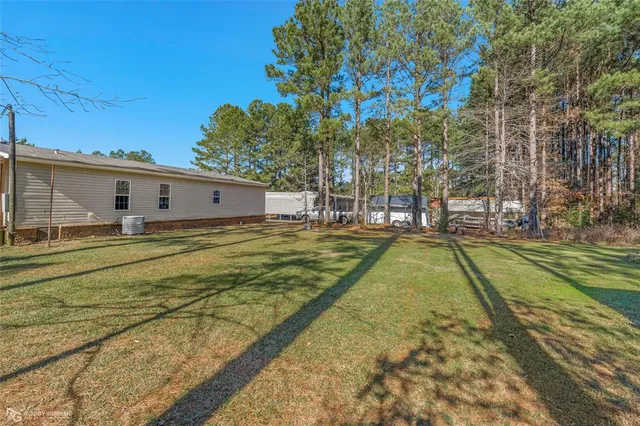 a view of yard with swimming pool and trees