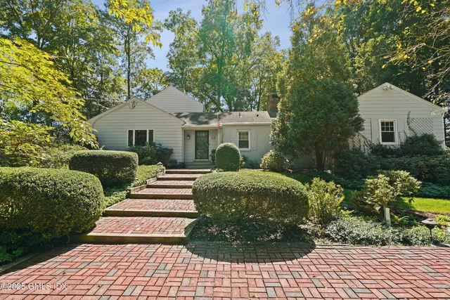a view of a hallway with wooden floor and livingroom