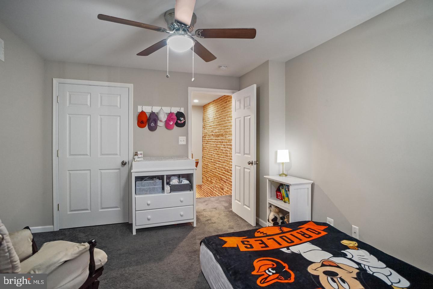 1421 Race Street Baltimore, MD 21230 - Photo 11 of 16 a bedroom with a bed and a chandelier