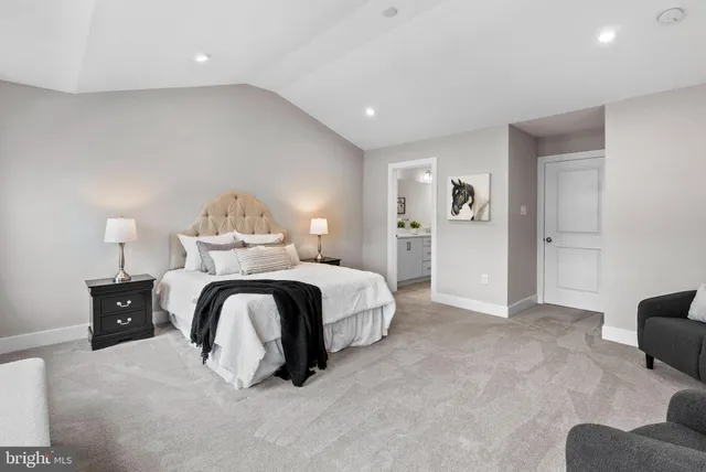 a spacious bedroom with a bed and furniture