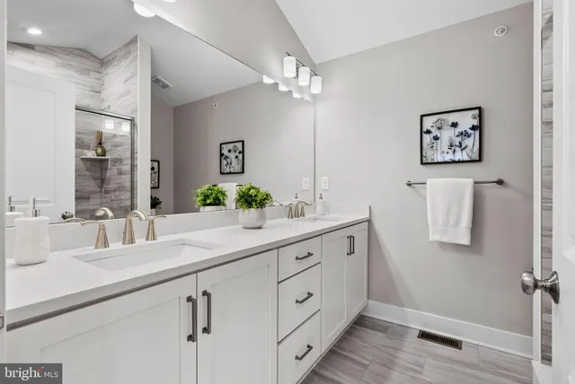 a bathroom with a double vanity sink and a mirror