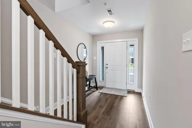 a view of a room with wooden floor and stairs