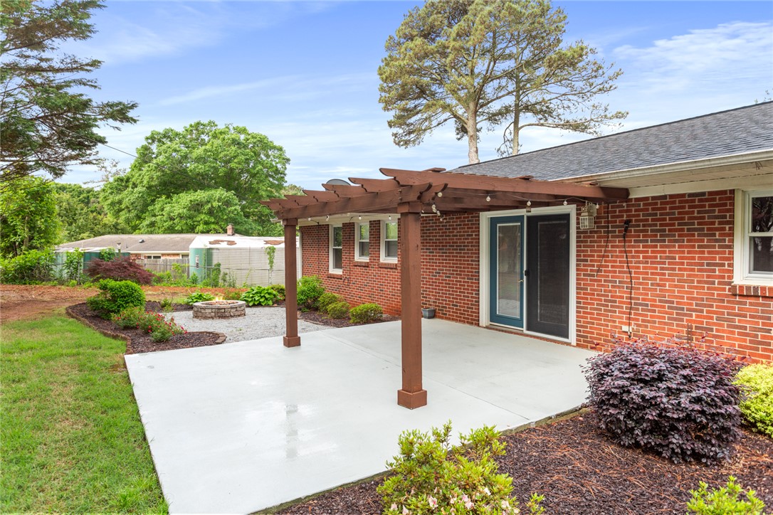 202 Keowee Trail Seneca, SC 29672 - Photo 29 of 35 This private backyard features a spacious patio and an inviting fire pit, perfect for outdoor enjoyment.