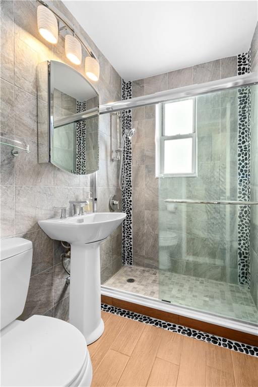 9707 4th Avenue, Unit 7H Brooklyn, NY 11209 - Photo 5 of 11 a bathroom with a sink toilet and shower