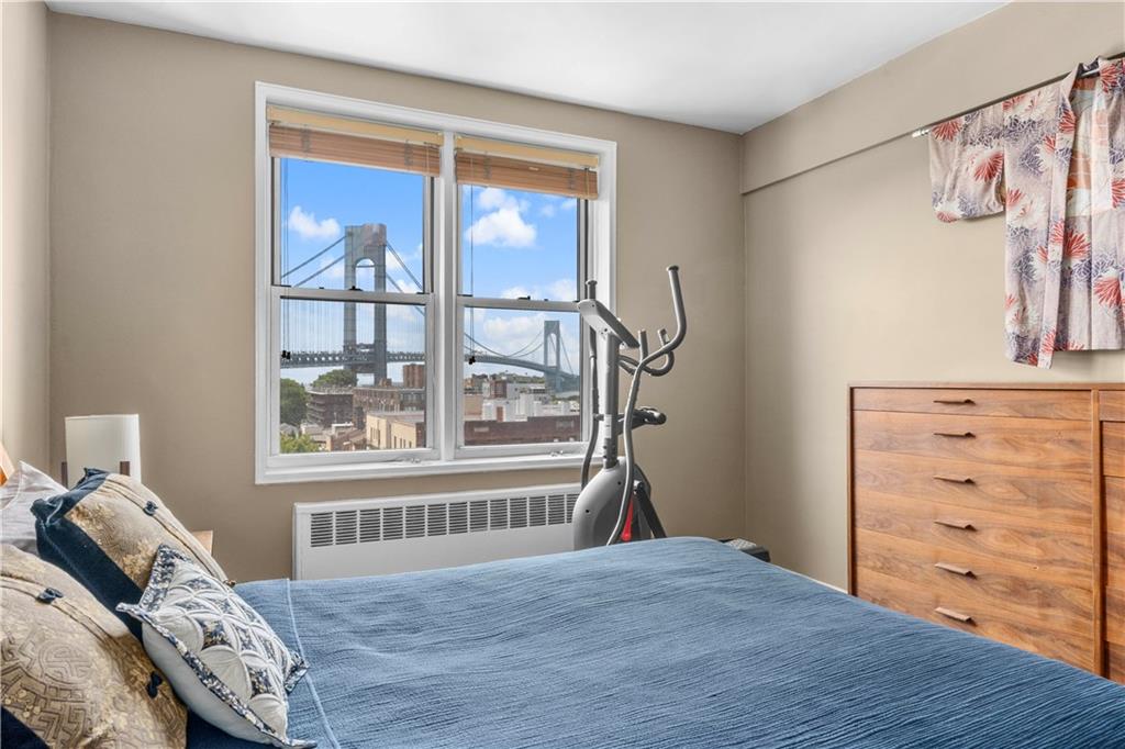 9707 4th Avenue, Unit 7H Brooklyn, NY 11209 - Photo 6 of 11 a bedroom with a bed and a window