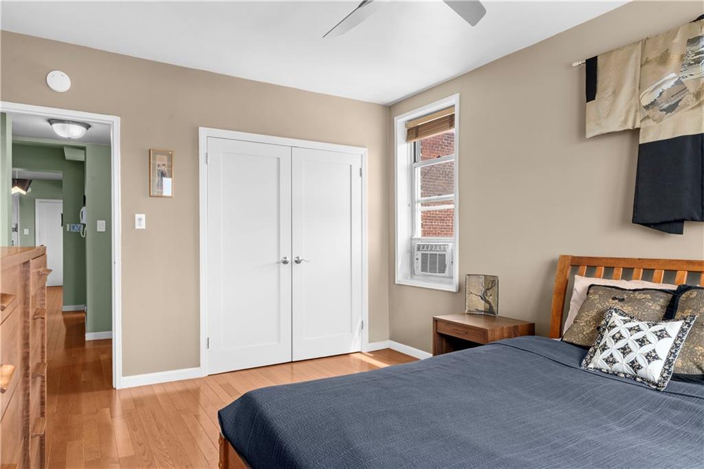 9707 4th Avenue, Unit 7H Brooklyn, NY 11209 - Photo 8 of 11 a bedroom with a bed and flat screen tv