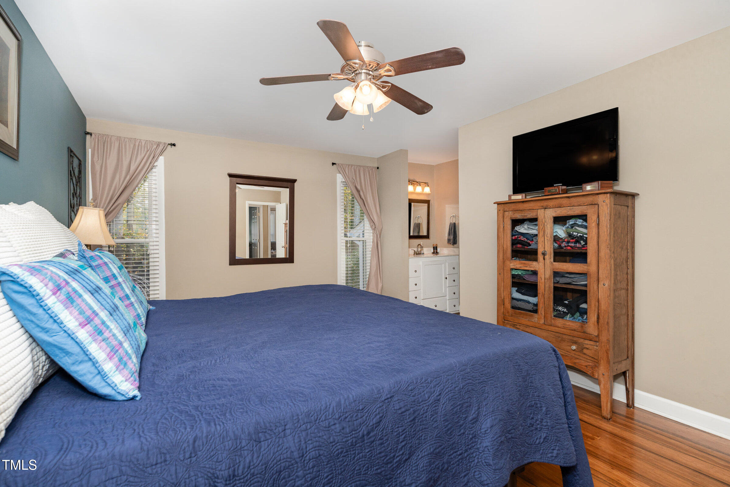 529 Ashebrook Drive Raleigh, NC 27609 - Photo 14 of 35 a view of a livingroom with a flat screen tv and a ceiling fan
